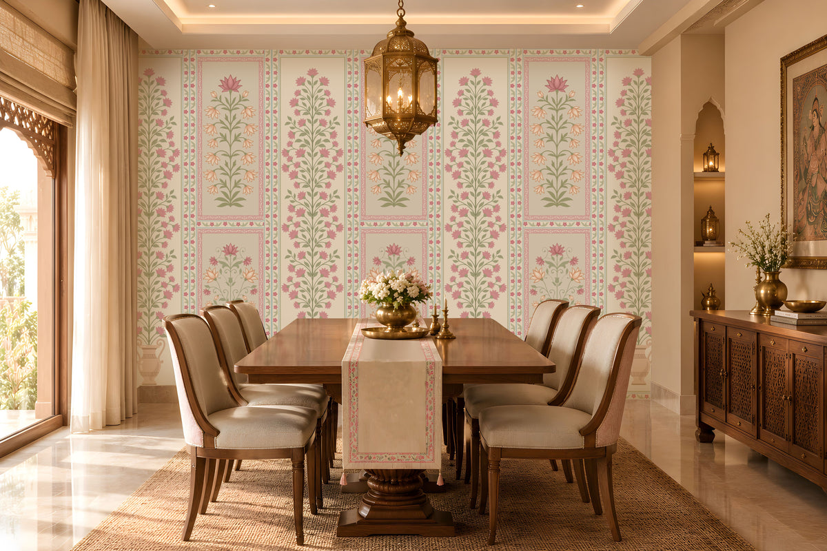 Elegant pastel floral wallpaper featuring delicate purple and peach flowers with soft sage-green vines on a light cream background, showcased in a luxurious Indian-style bedroom with ornate ivory furniture, blush pink accents, traditional arched windows, and warm chandelier lighting.