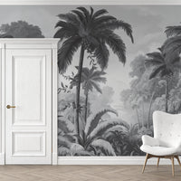 An architectural perspective of a contemporary lounge featuring the Luxe Tropical Greens Mural in Grey as a full-scale feature wall. The mural’s expansive jungle vista pairs elegantly with sleek stone surfaces and polished metal accents, creating a peaceful and cultured interior sanctuary.