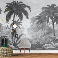 An architectural perspective of a contemporary lounge featuring the Luxe Tropical Greens Mural in Grey as a full-scale feature wall. The mural’s expansive jungle vista pairs elegantly with sleek stone surfaces and polished metal accents, creating a peaceful and cultured interior sanctuary.