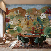 An architectural perspective of a luxury dining room featuring the Krishna Pichwai Mural as a full-scale narrative feature wall. The mural’s earthy tones and divine blue accents pair strikingly with a dark wood circular dining table, forest green velvet chairs, and traditional Persian rugs, creating a sophisticated and spiritually resonant interior.