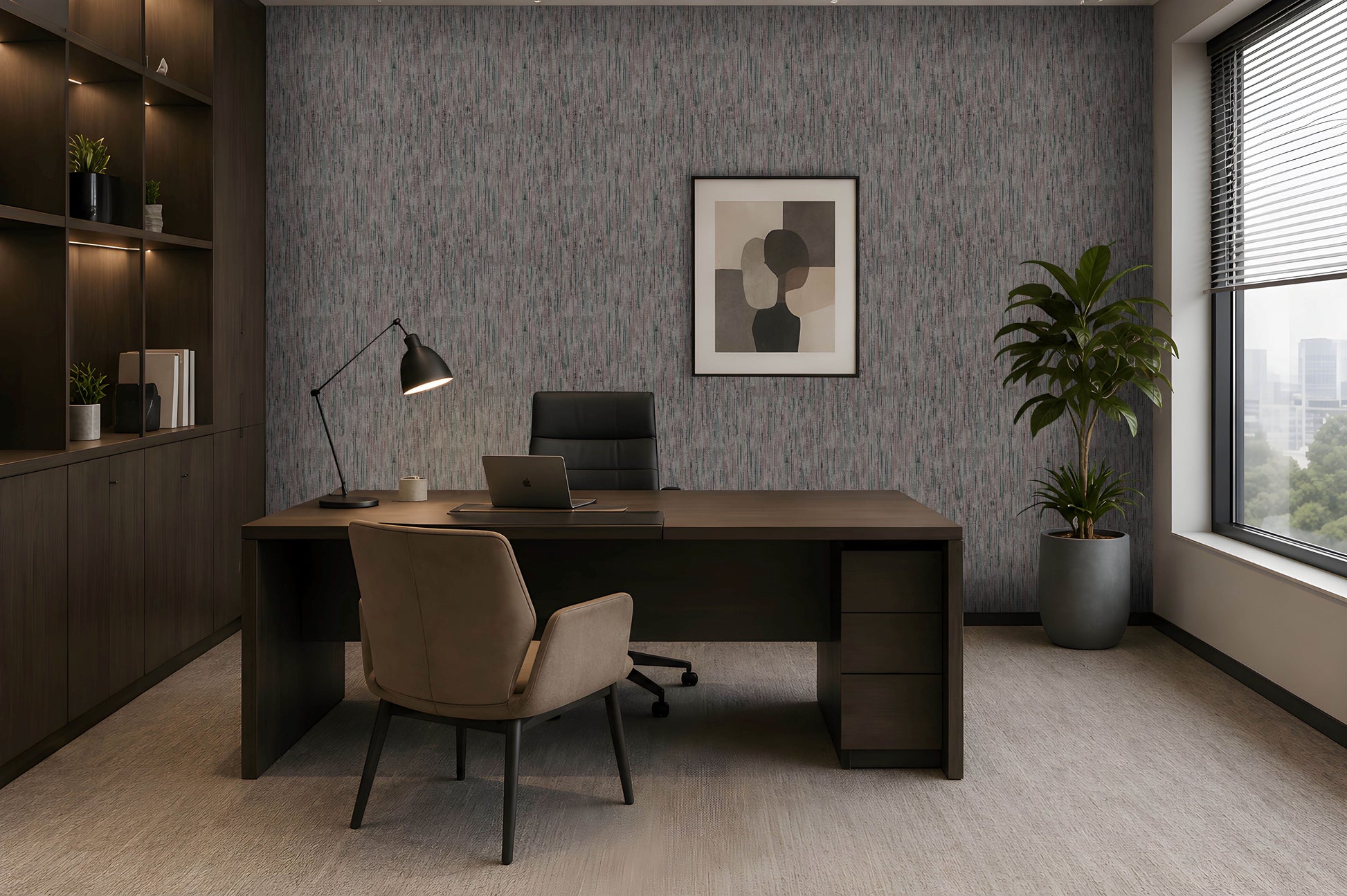 A modern home office setup featuring a dark wood desk with a beige upholstered chair, set against a textured gray wall with a framed abstract print. A black office chair, desk lamp, and a potted green plant are arranged around the desk, with a built-in wooden shelving unit on the left and a large window on the right.