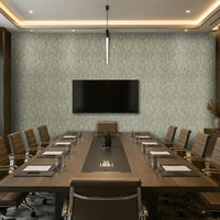 A modern conference room with a long rectangular wooden table, multiple brown office chairs, a large wall-mounted TV, patterned blue-gray wallpaper, recessed ceiling lighting, and a large framed abstract artwork on the right wall.