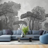 An architectural perspective of a contemporary lounge featuring the Mediterranean Reverie Forest Mural in Ash Grey as a full-scale feature wall. The mural’s expansive forest vista pairs strikingly with sleek stone surfaces and polished metal accents, creating a peaceful and cultured interior sanctuary.