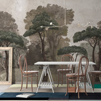An architectural perspective of a contemporary lounge featuring the Mediterranean Reverie Forest Mural in Lazy Afternoon as a full-scale feature wall. The mural’s expansive forest vista pairs strikingly with natural textures and comfortable furniture, creating a peaceful and cultured interior sanctuary.