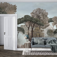 An architectural perspective of a contemporary lounge featuring the Mediterranean Reverie Forest Mural in Stormy Bay as a full-scale feature wall. The mural’s expansive forest vista pairs strikingly with crisp white furniture and metallic accents, creating a peaceful and cultured interior sanctuary.