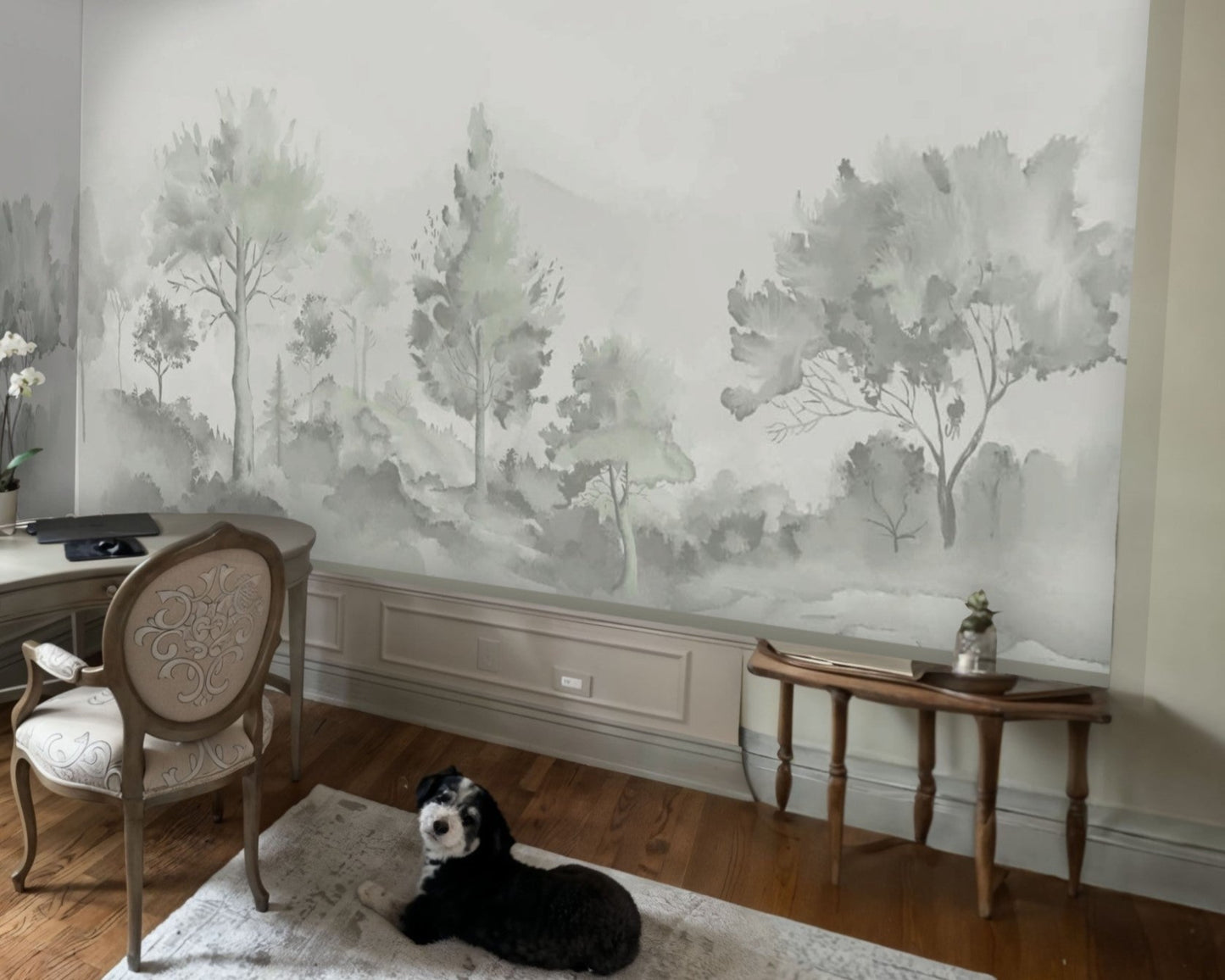 An architectural perspective of a luxury interior featuring the Minimalist Watercolour Tree Mural in Soft Sage Grey. The mural’s misty, receding landscape creates a sense of infinite horizon and organic calm, perfectly complementing minimalist furniture, natural wood accents, and soft, neutral upholstery.