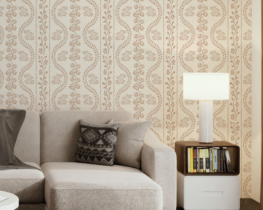 A high-resolution detail of the Floral Seamless Wallpaper in Muted Beige, showcasing the rhythmic vertical vine structure and delicate botanical sprigs. The image highlights the fine, hand-drawn illustrative style and the soothing, neutral tones of the tan and cream palette.