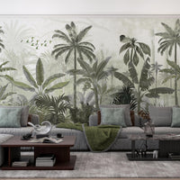 An architectural perspective of a contemporary lounge or office space featuring the Mystic Rainforest Haven Mural in Pale Olive as a full-scale feature wall. The mural’s expansive botanical vista pairs elegantly with natural rattan furniture and linen textiles, creating a peaceful and cultured interior sanctuary.