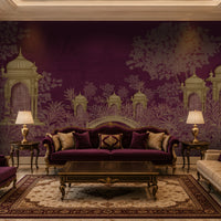 An ornate living room featuring a large purple and beige wallpaper mural with classical domed architecture, styled with a deep purple velvet sofa, matching armchair, cream sofa, and a patterned area rug.