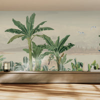 An architectural perspective of a modern living space featuring the Coastal Canopy Mural in Pale Ochre as a full-width panoramic feature wall. The mural’s expansive landscape pairs elegantly with natural wood flooring and minimalist furniture, creating a peaceful, sun-soaked retreat.