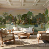 A panoramic Pichwai wallpaper mural featuring a divine Vrindavan Garden scene with hand-painted peacocks, spotted deer, and traditional figures. The design showcases lush tropical trees and a sunset-hued sky, bringing a royal Indian heritage aesthetic to a luxury living room.