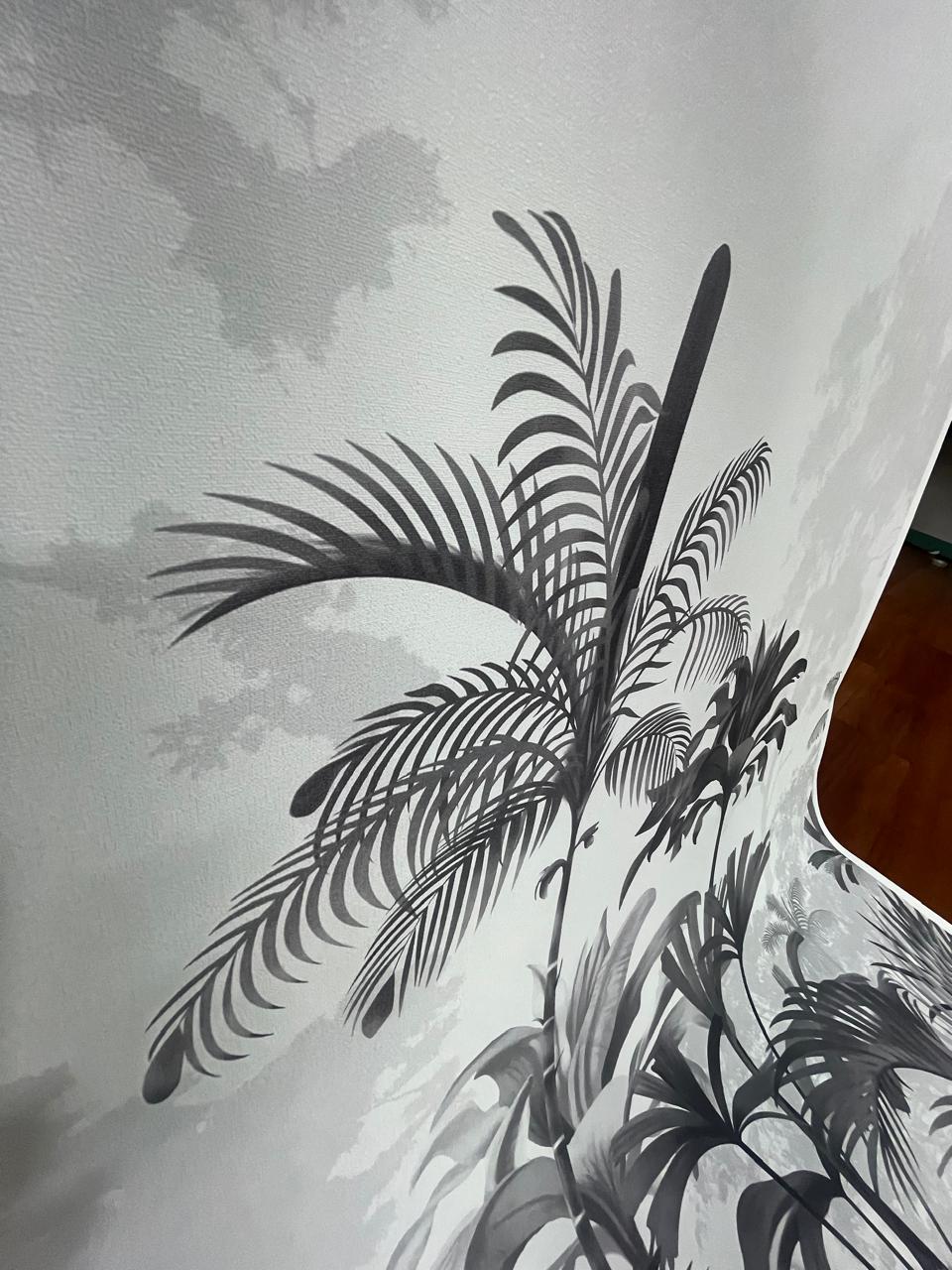 An architectural perspective of a high-ceilinged contemporary lounge featuring the Paradise Palms Mural in Ivory White as a full-scale feature wall. The mural’s expansive botanical vista pairs elegantly with light-toned furniture and organic textures, creating a peaceful and cultured interior sanctuary.