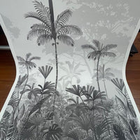 An architectural perspective of a high-ceilinged contemporary lounge featuring the Paradise Palms Mural in Ivory White as a full-scale feature wall. The mural’s expansive botanical vista pairs elegantly with light-toned furniture and organic textures, creating a peaceful and cultured interior sanctuary.