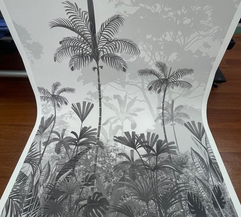 An architectural perspective of a high-ceilinged contemporary lounge featuring the Paradise Palms Mural in Ivory White as a full-scale feature wall. The mural’s expansive botanical vista pairs elegantly with light-toned furniture and organic textures, creating a peaceful and cultured interior sanctuary.
