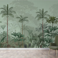An architectural perspective of a high-ceilinged contemporary lounge featuring the Paradise Palms Mural in Sage Green as a full-scale feature wall. The mural’s expansive botanical vista pairs elegantly with mid-century modern furniture and natural sunlight, creating a peaceful and cultured interior sanctuary.