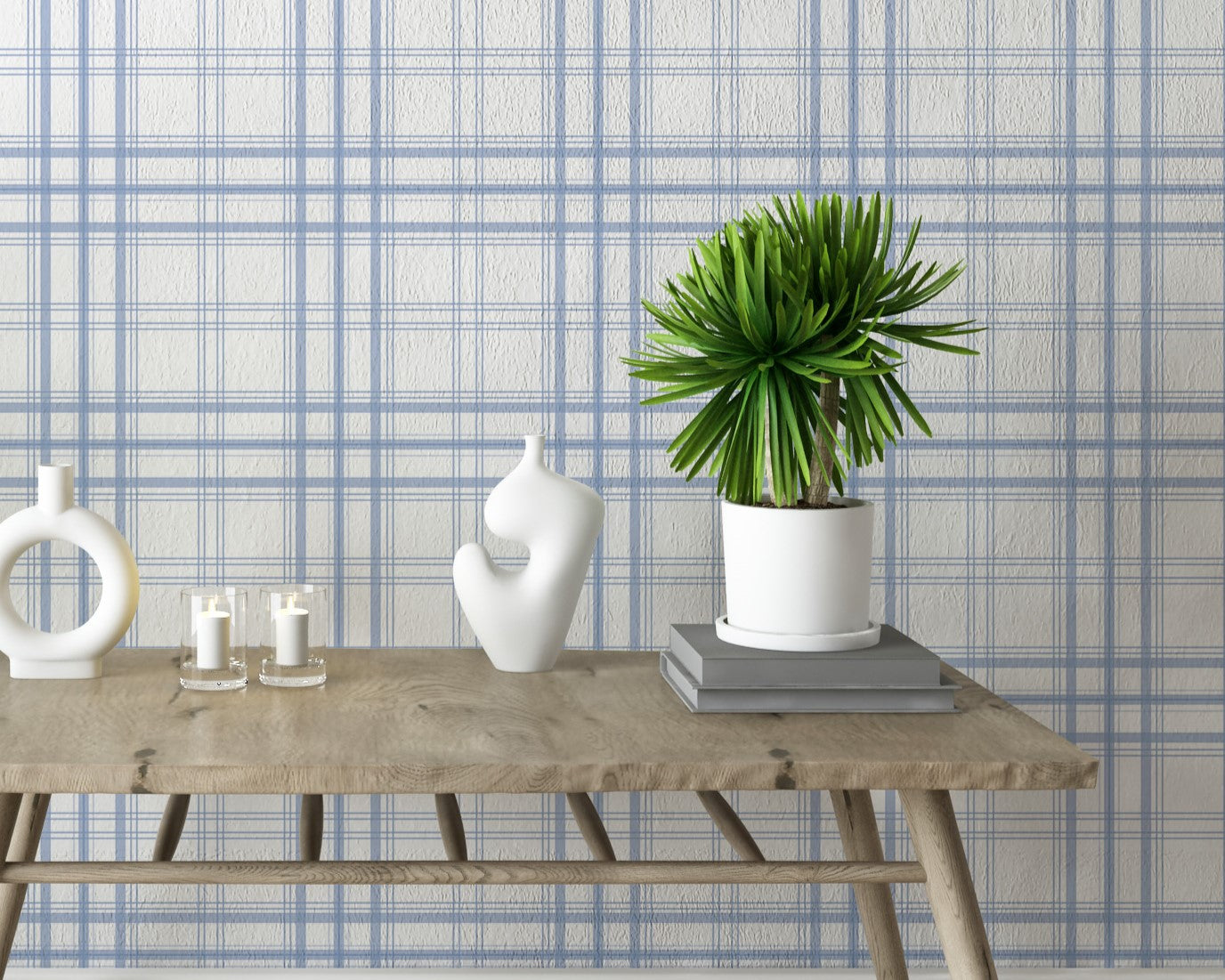 A bright interior space features a soft ivory and cornflower blue plaid wallpaper.
The detailed design shows thin blue lines intersecting to form clean grids across a white base.
In front, a rustic wooden console table holds modern ceramic vases and candles.
The breezy, minimalist setup is accented with vibrant green potted plants on both sides.