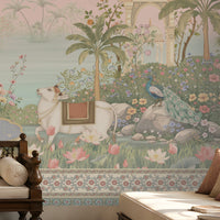 Radha Madhav pink heritage wall mural in a luxury Indian living room with carved wooden seating, floral cushions, brass décor, and traditional rug.