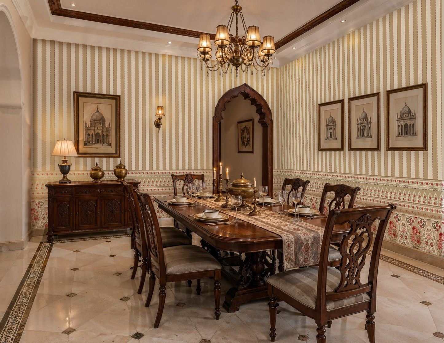Traditional dining room featuring heritage-inspired cream and blush striped wallpaper with an ornate floral border, carved wooden dining table and chairs, vintage chandelier, classic artwork, and elegant Indian-inspired architectural details creating a warm and luxurious ambiance.