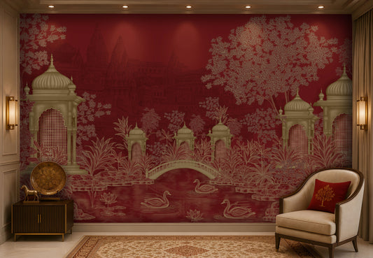 Elegant living room featuring a heritage-inspired mural in rich crimson red and antique gold. The mural showcases ornate domed pavilions, lush botanical foliage, an arched bridge, blooming lotus flowers, and graceful swans on a tranquil pond, with subtle palace architecture in the background. The space is styled with a cream upholstered accent chair, a burgundy embroidered cushion, dark wood furniture, brass decorative accents, a patterned beige rug, and warm ambient lighting, creating a luxurious atmospher