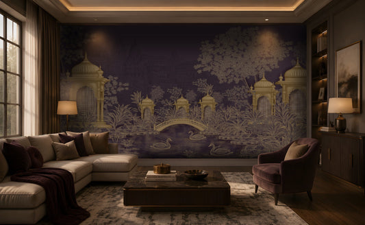 Contemporary luxury living room featuring a heritage-inspired mural in deep royal plum and antique gold. The mural depicts ornate domed pavilions, lush botanical foliage, an elegant arched bridge, blooming lotus flowers, and graceful swans on a tranquil pond, with subtle palace architecture in the background. The room is furnished with a cream sectional sofa, a plush mauve accent chair, dark wood cabinetry, a marble-top coffee table, layered neutral textiles, and warm ambient lighting, creating a sophistica
