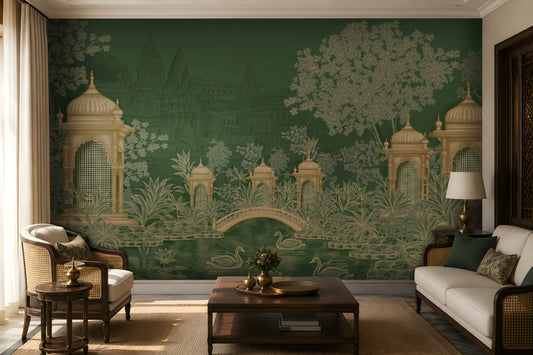 Elegant living room featuring a heritage-inspired mural in deep forest green and antique gold. The mural depicts ornate domed pavilions, lush botanical foliage, a graceful arched bridge, and swans gliding across a tranquil pond, with faint palace architecture in the background. The space is styled with ivory upholstered cane armchairs and sofa, dark wood furniture, green accent cushions, warm brass décor, a wooden coffee table, a natural jute rug, and soft ambient lighting, creating a refined, timeless atmo