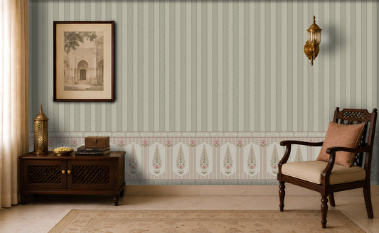 Elegant vintage-inspired sitting room with sage green vertically striped wallpaper, ornate patterned wainscoting, a framed architectural print, brass wall sconces, a dark wooden sideboard with decorative objects, and a carved wooden armchair with a beige cushion and patterned pillow.
