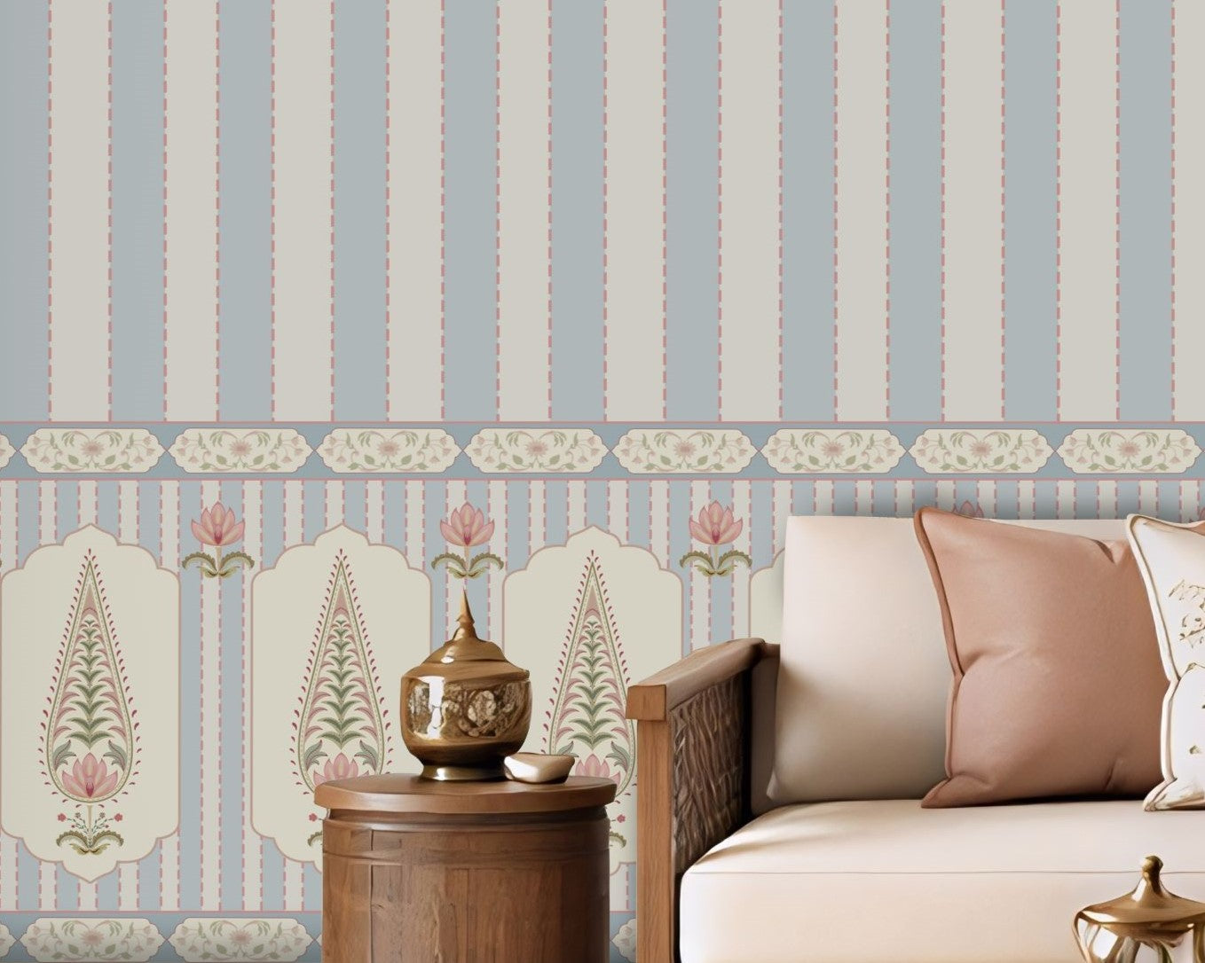 A styled living room featuring a prominent light blue and white vertical striped wallpaper with a decorative border along the bottom. The room is furnished with a cream-colored sectional sofa, wooden coffee table, and neutral-toned decor.