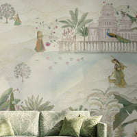 Royal Vrindavan Pichwai wallpaper mural in soft pastel sage green, beige and blush pink tones featuring Indian palace gardens, trees, peacocks and scenic landscape design in a luxury living room setting.