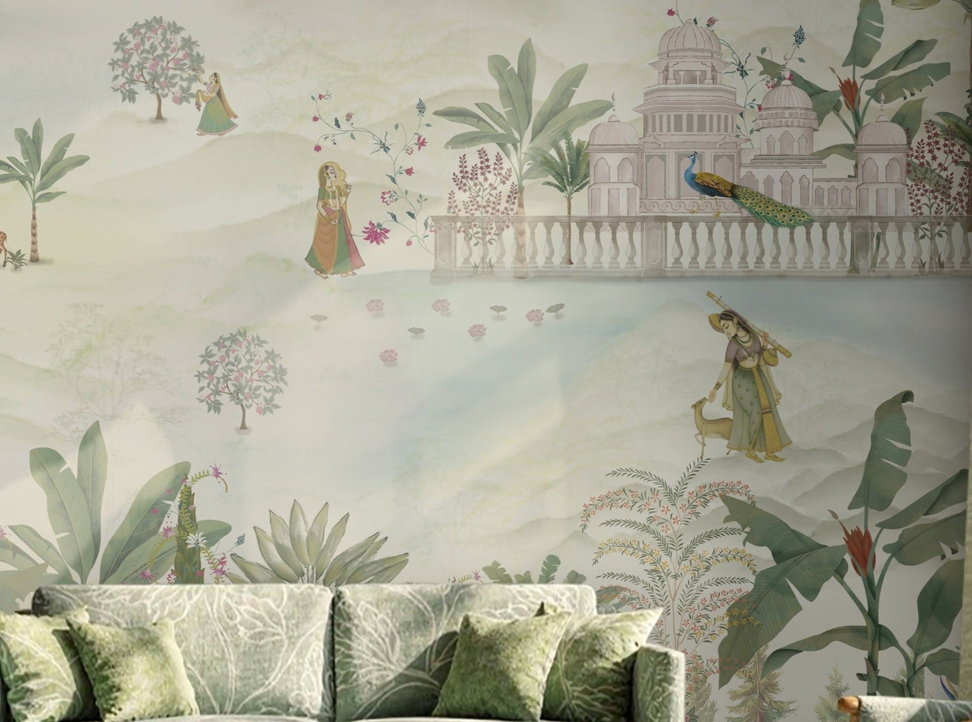 Royal Vrindavan Pichwai wallpaper mural in soft pastel sage green, beige and blush pink tones featuring Indian palace gardens, trees, peacocks and scenic landscape design in a luxury living room setting.
