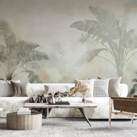 A high-resolution detail of the Sage Green Tropical Wallpaper, highlighting the delicate, feathered textures of the large palm fronds. The image showcases the subtle watercolor-style gradients and the soft, misty background that defines this nature-inspired feature wall.