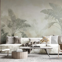 An architectural perspective of a modern, luxury living room featuring the Sage Green Tropical Palm Mural as a full-scale feature wall. The mural’s soft, ethereal tones pair perfectly with contemporary low-profile seating, marble accents, and rich wood paneling to create a high-end sanctuary.