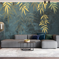 An architectural perspective of a contemporary lounge featuring the Sasa Leaves Mural in Evergreen Blue as a full-scale feature wall. The mural’s cool, forest-inspired tones pair elegantly with dark wood furniture, emerald velvet upholstery, and brass accents, creating a balanced and cultured interior sanctuary.