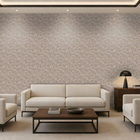 A modern living room featuring a large wall covered in beige and white abstract patterned wallpaper, styled with a cream sofa, two matching armchairs, a dark wood coffee table, and a black table lamp.