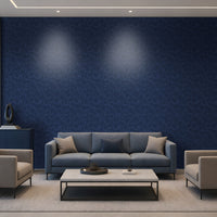 A modern living room setup featuring a prominent dark blue textured wallpaper accent wall behind a gray three-seater sofa, flanked by two light gray armchairs and a white coffee table.