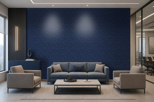 A modern living room setup featuring a prominent dark blue textured wallpaper accent wall behind a gray three-seater sofa, flanked by two light gray armchairs and a white coffee table.