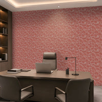 A modern office interior featuring a large desk, gray chairs, and a prominent pink patterned wallpaper on the back wall.