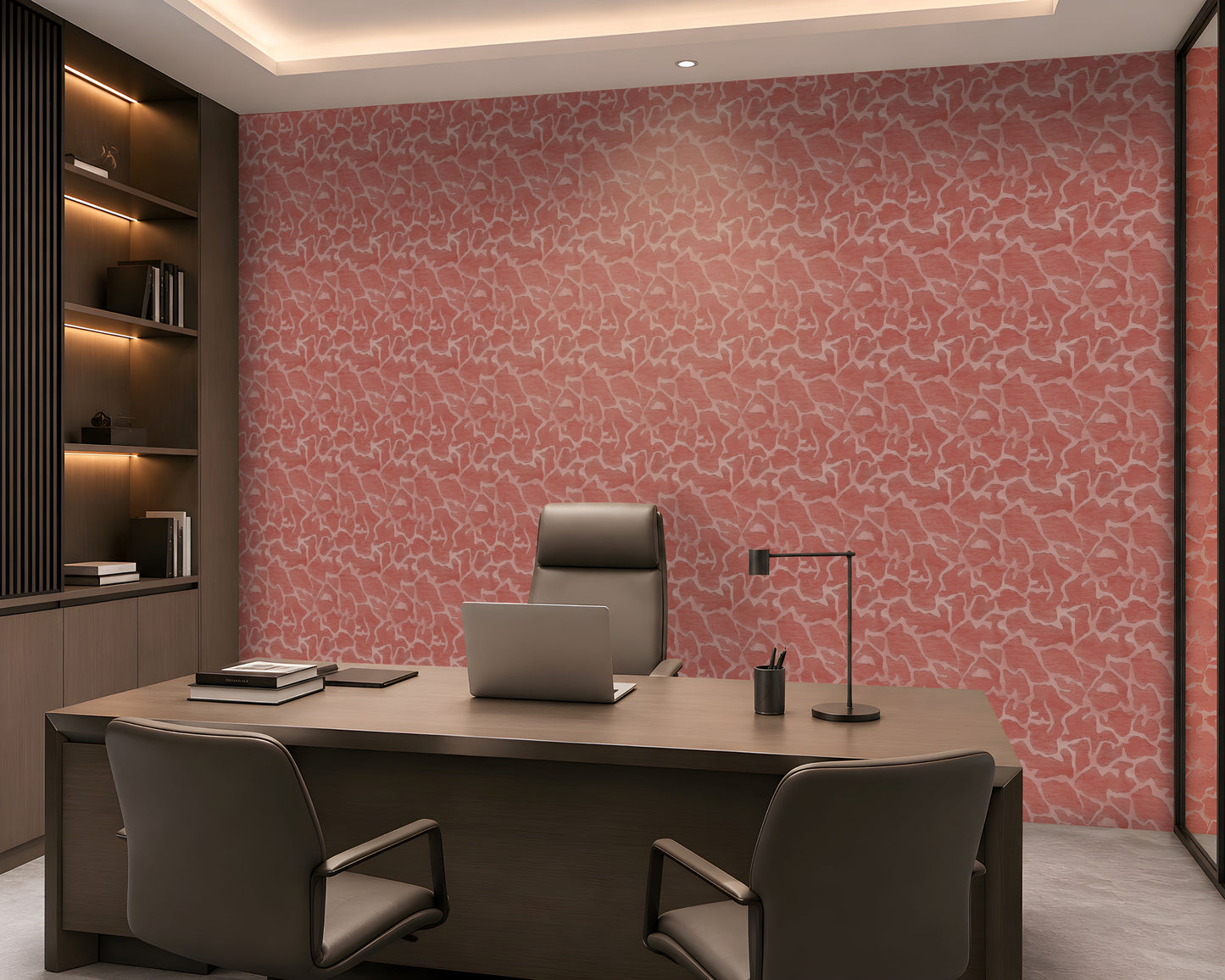 A modern office interior featuring a large desk, gray chairs, and a prominent pink patterned wallpaper on the back wall.