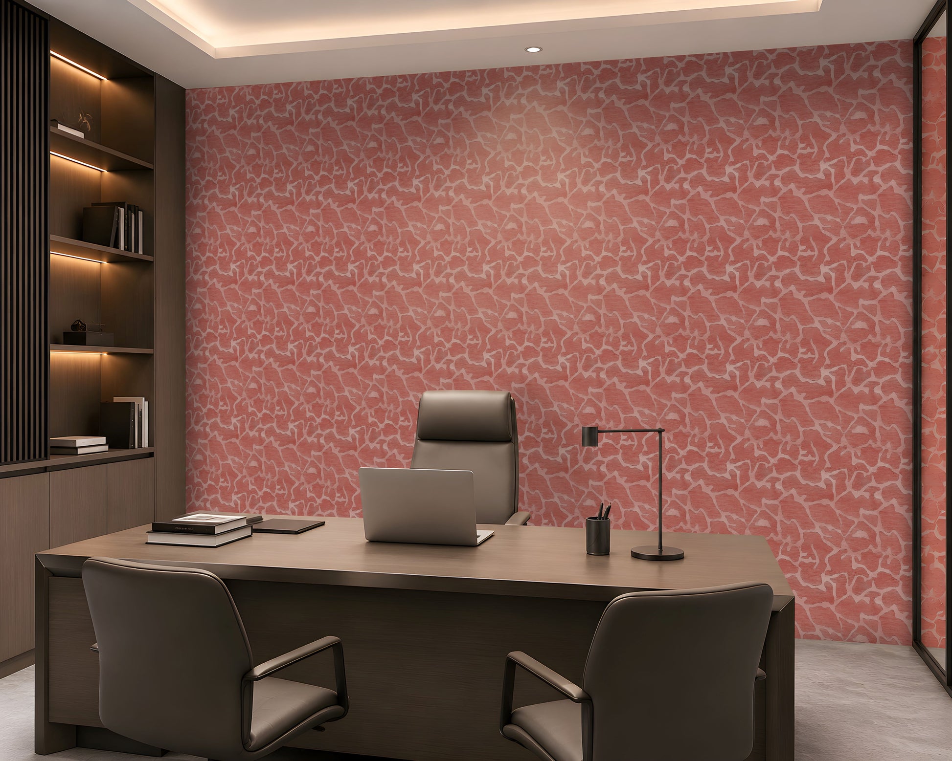 A modern office interior featuring a large desk, gray chairs, and a prominent pink patterned wallpaper on the back wall.