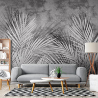 "Enhance your space with the Shaded Palmscape Tropical Palm Leaf Mural in Muted Gray. Featuring layered palm fronds in a sophisticated slate and ash palette, this artisan mural adds a moody, serene botanical feel to any modern room."
