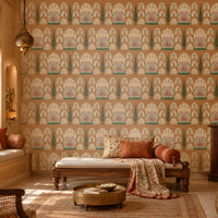 Shriji Darbar Heritage Wallpaper featuring intricate Indian palace arches, royal court illustrations, and elegant cypress tree motifs on a warm terracotta beige background, displayed in a luxurious traditional living room with carved wooden furniture, ethnic textiles, and brass décor accents.