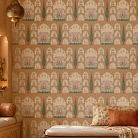 Shriji Darbar Heritage Wallpaper featuring intricate Indian palace arches, royal court illustrations, and elegant cypress tree motifs on a warm terracotta beige background, displayed in a luxurious traditional living room with carved wooden furniture, ethnic textiles, and brass décor accents.