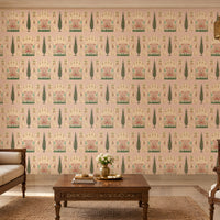 Shriji Darbar Heritage Wallpaper in soft powder pink with intricate Indian palace architecture, royal darbar scenes, decorative arches, and cypress tree motifs in a seamless repeating pattern, displayed in a traditional luxury living room with carved wooden furniture and warm ethnic décor.