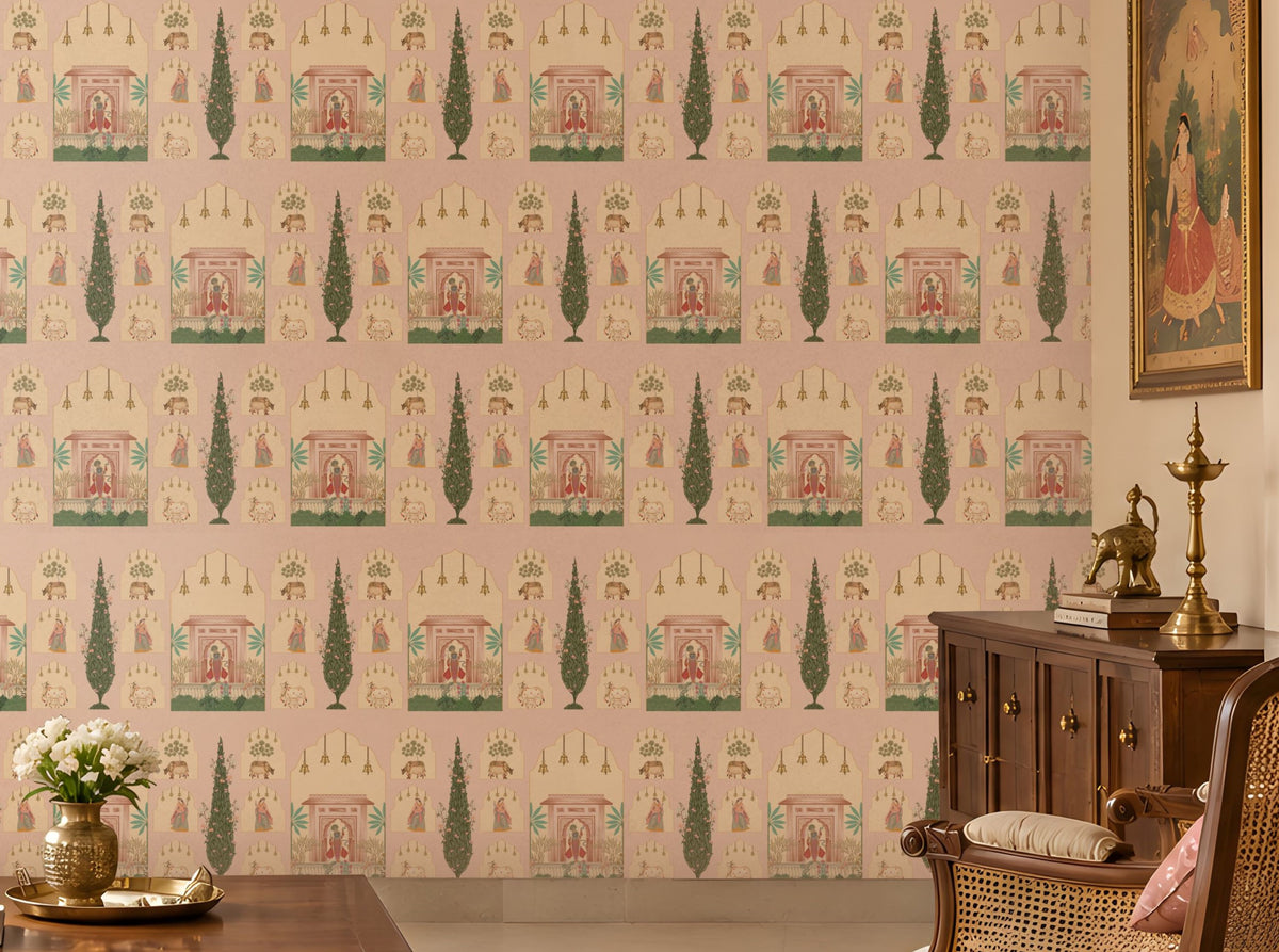 Shriji Darbar Heritage Wallpaper in soft powder pink with intricate Indian palace architecture, royal darbar scenes, decorative arches, and cypress tree motifs in a seamless repeating pattern, displayed in a traditional luxury living room with carved wooden furniture and warm ethnic décor. 