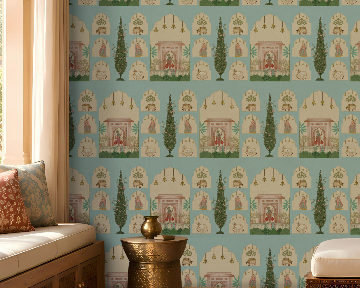 Shriji Darbar Heritage Wallpaper in soft sky aqua blue featuring traditional Indian palace arches, royal court scenes, ornamental motifs, and elegant cypress trees in a seamless repeating pattern, showcased in a sophisticated living room with carved wooden furniture, brass accents, and warm natural light.