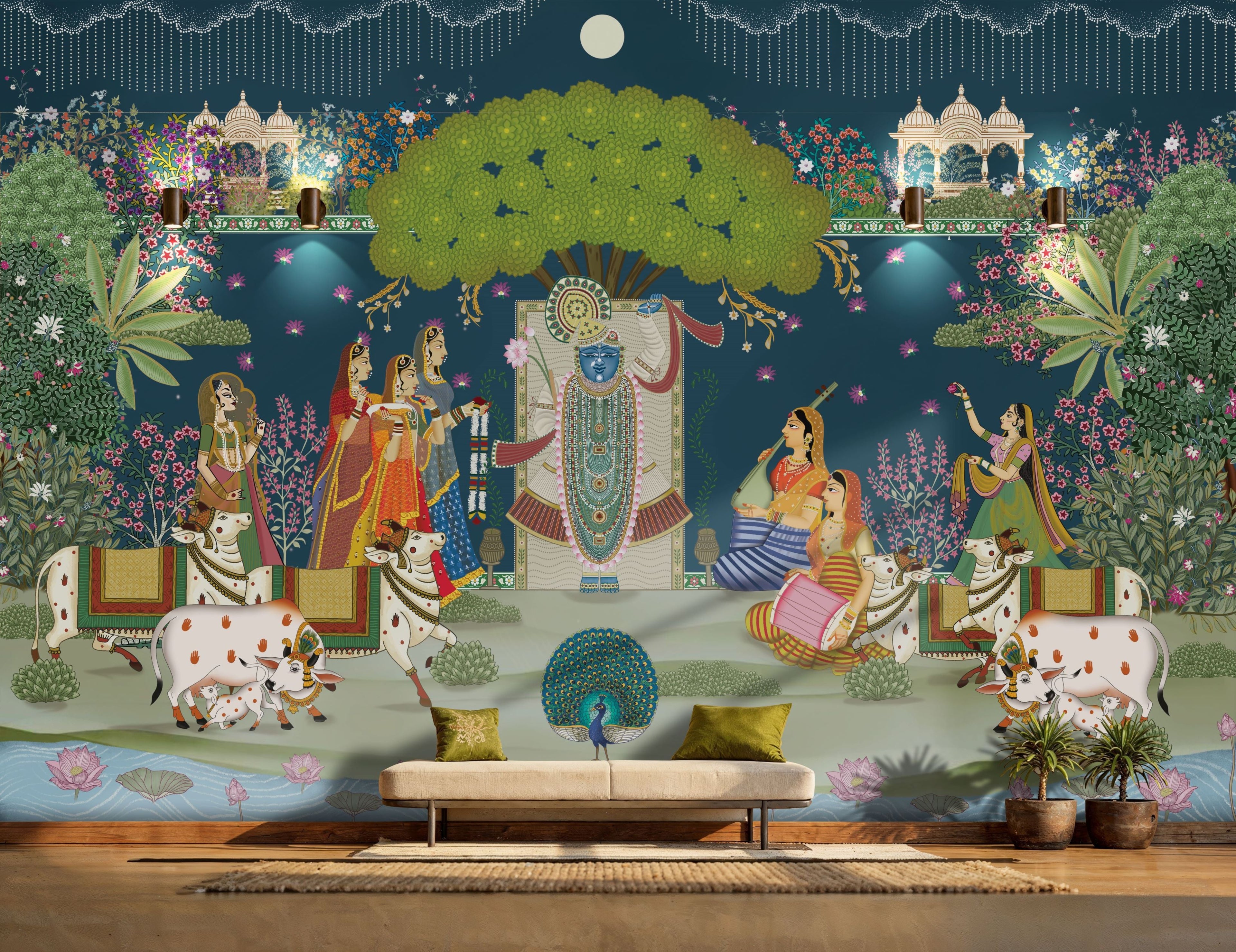 A traditional Pichwai wall mural depicting Lord Shrinathji with Gopis and holy cows under a large green tree against a deep blue background in a luxury living room.