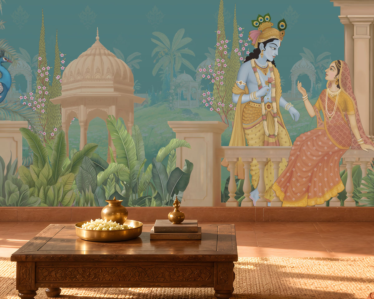 A large wall mural featuring an Indian classical scene with a blue peacock, a seated king and queen, palm trees, domes, and a teal background, shown installed in a warmly lit living room with a sofa, coffee table, and plants.