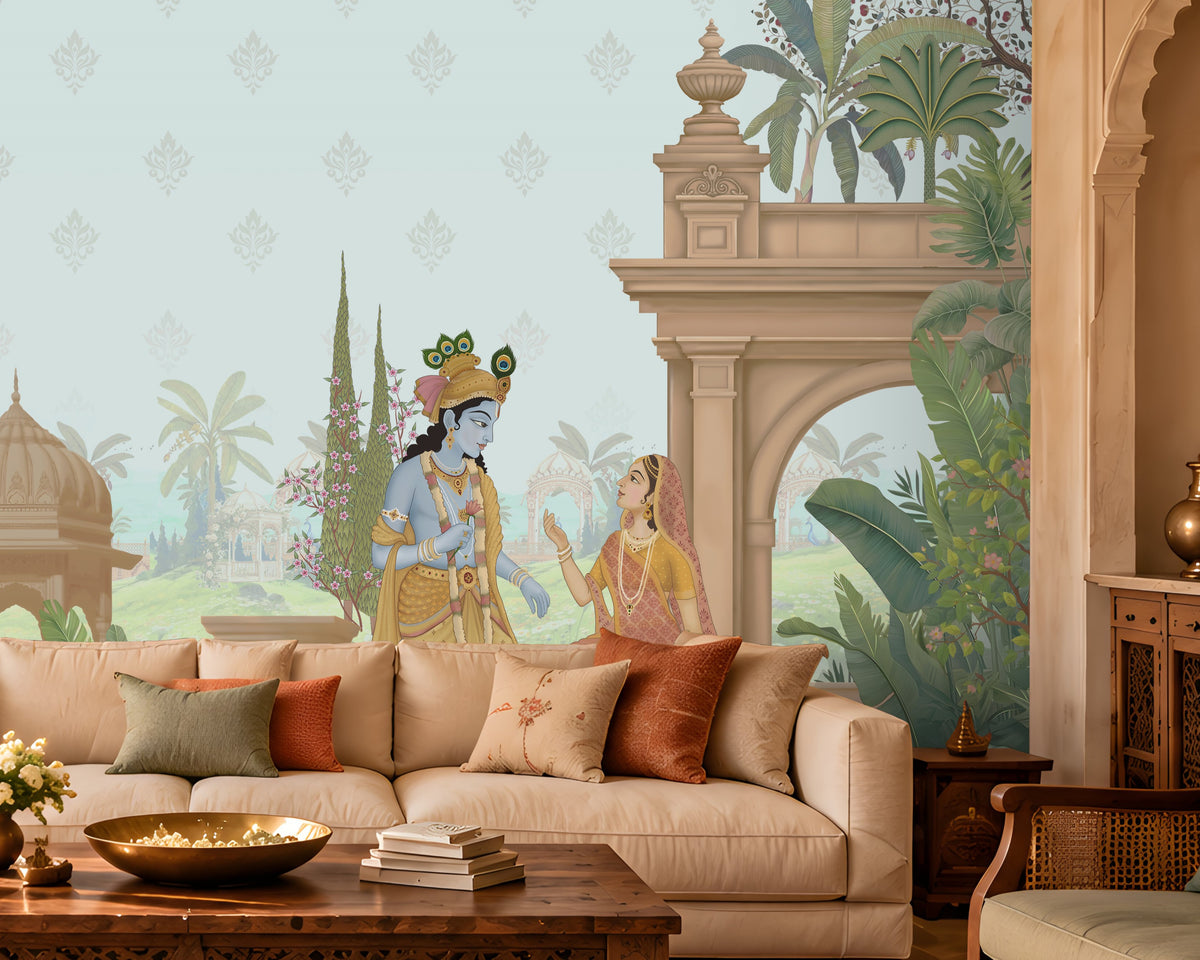 A styled living room featuring a large wall mural with a classical Indian scene, including a peacock, a woman in a blue sari, and architectural pillars, set behind a cream sectional sofa with decorative pillows.