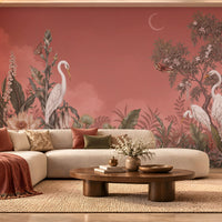 Artistic mural illustration featuring elegant white herons standing amidst a dense, lush tropical garden under a muted peach sky. In the foreground, detailed green foliage, exotic leaves, and blooming cream-colored lotus-like flowers fill the lower frame. A crescent moon glows faintly, near the canopy of a flowering tree, where butterflies flutter near the branches and leaves.