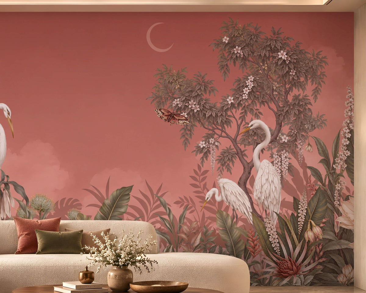 Artistic mural illustration featuring elegant white herons standing amidst a dense, lush tropical garden under a muted peach sky. In the foreground, detailed green foliage, exotic leaves, and blooming cream-colored lotus-like flowers fill the lower frame. A crescent moon glows faintly, near the canopy of a flowering tree, where butterflies flutter near the branches and leaves.