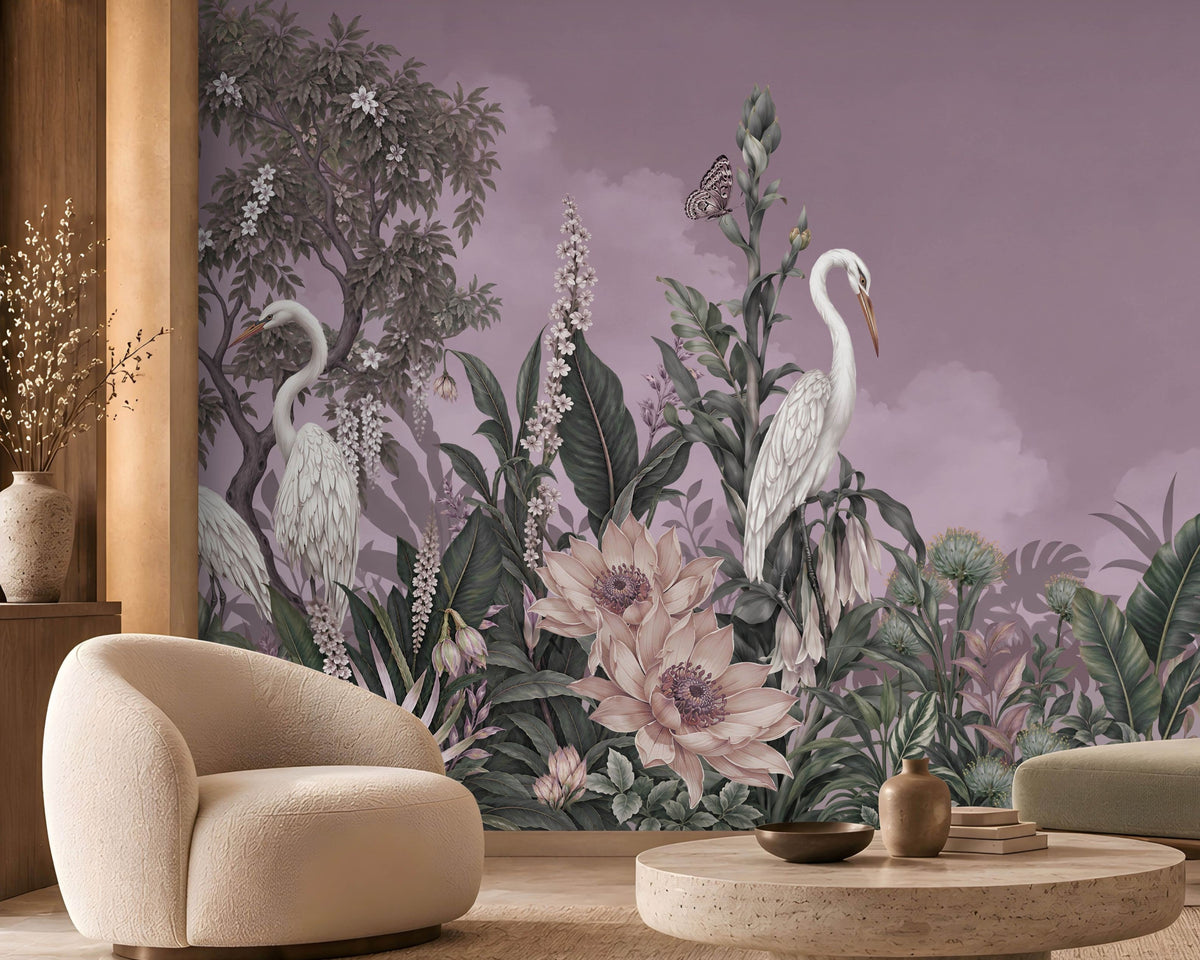 Whimsical mural featuring white herons amidst lush tropical flora dominates the back wall of a modern, neutral-toned living room. The mural displays a muted purple backdrop with a crescent moon, detailed green foliage, pale ivory blossoms, and tall trees.